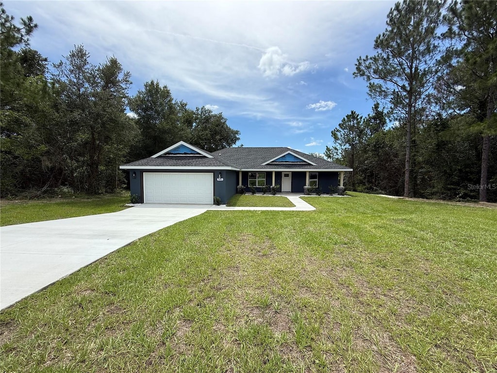 7946 N Manville Rd, Citrus Springs, FL 34434 - ranch-style home with a front yard, concrete driveway, and an attached garage