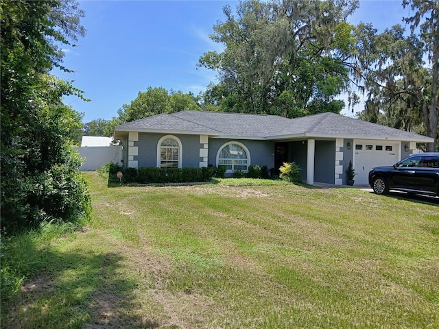 309 N Westwood St, Bushnell, FL 33513 - ranch-style house with an attached garage and stucco siding