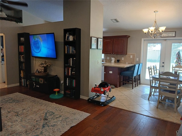 309 N Westwood St, Bushnell, FL 33513 - living room with a chandelier, light wood finished floors, ceiling fan, and french doors