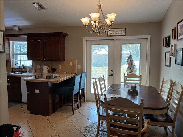 309 N Westwood St, Bushnell, FL 33513 - dining space with a chandelier, light tile patterned floors, and french doors