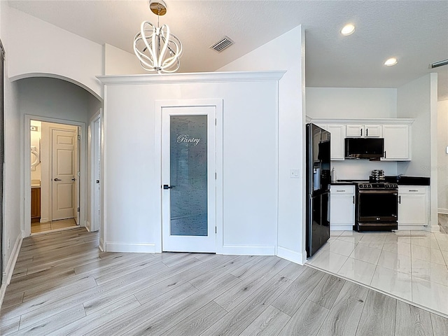 2421 Cimmaron Ash Way, Apopka, FL 32703 - unfurnished dining area with arched walkways, a chandelier, light wood-style floors, and recessed lighting