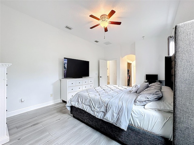 2421 Cimmaron Ash Way, Apopka, FL 32703 - bedroom featuring arched walkways, light wood-style flooring, and a ceiling fan