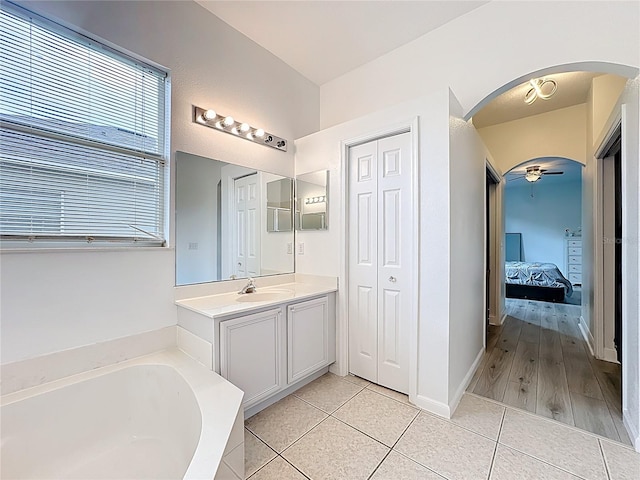 2421 Cimmaron Ash Way, Apopka, FL 32703 - ensuite bathroom featuring vanity, a bath, tile patterned flooring, and a closet