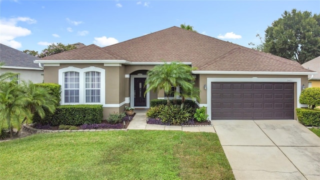 2421 Cimmaron Ash Way, Apopka, FL 32703 - view of front of house with stucco siding, driveway, a front lawn, and an attached garage