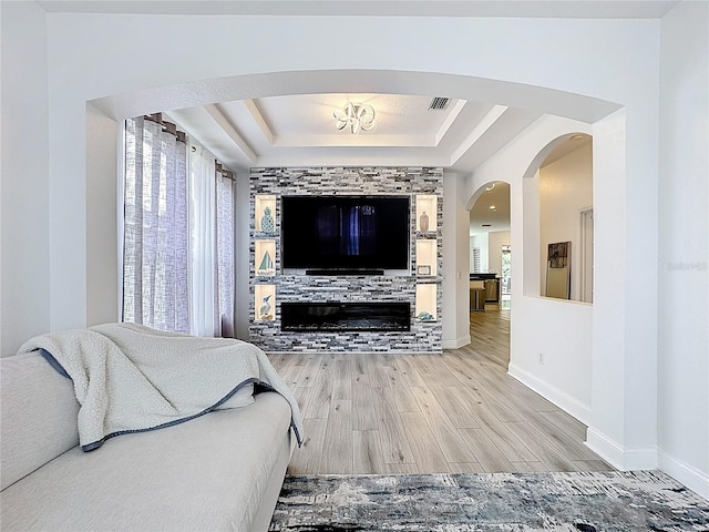 2421 Cimmaron Ash Way, Apopka, FL 32703 - living area featuring a tray ceiling and wood finished floors