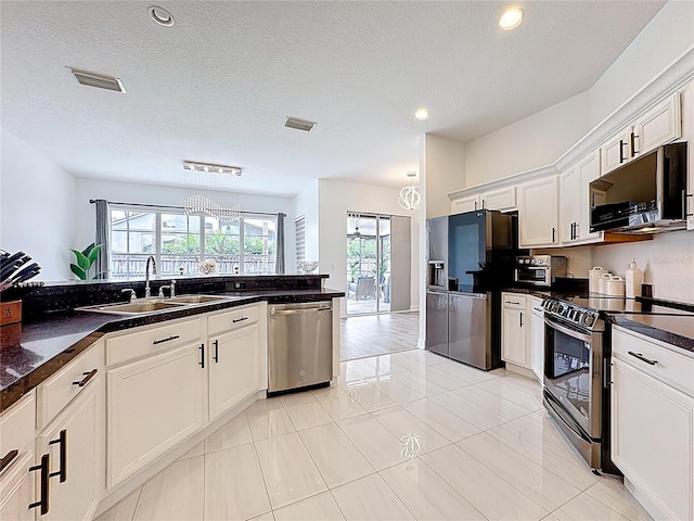 2421 Cimmaron Ash Way, Apopka, FL 32703 - kitchen with stainless steel appliances, dark countertops, white cabinetry, recessed lighting, and light tile patterned floors
