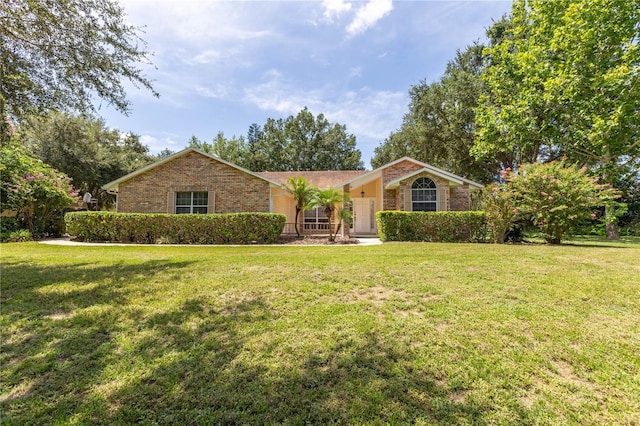 14933 Thoroughbred Ln, Montverde, FL 34756 - ranch-style house with a front yard and brick siding