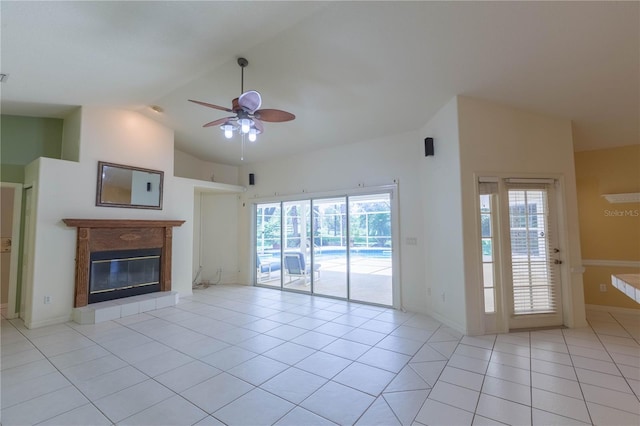 14933 Thoroughbred Ln, Montverde, FL 34756 - unfurnished living room with a ceiling fan, tile patterned floors, a glass covered fireplace, and high vaulted ceiling