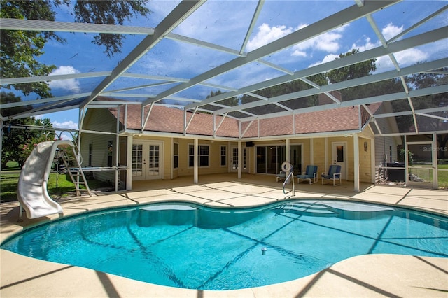 14933 Thoroughbred Ln, Montverde, FL 34756 - swimming pool with french doors, a patio, a water slide, and a lanai