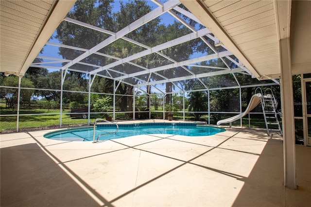 14933 Thoroughbred Ln, Montverde, FL 34756 - outdoor pool featuring a patio area, a water slide, view of wooded area, and a lanai