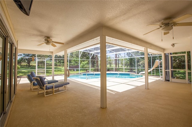 14933 Thoroughbred Ln, Montverde, FL 34756 - swimming pool featuring ceiling fan, a water slide, a patio, and a lanai
