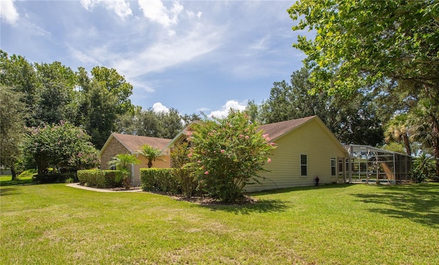 14933 Thoroughbred Ln, Montverde, FL 34756 - view of side of home with a yard and glass enclosure