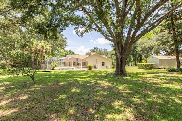 14933 Thoroughbred Ln, Montverde, FL 34756 - view of grassy yard featuring an outdoor pool and glass enclosure