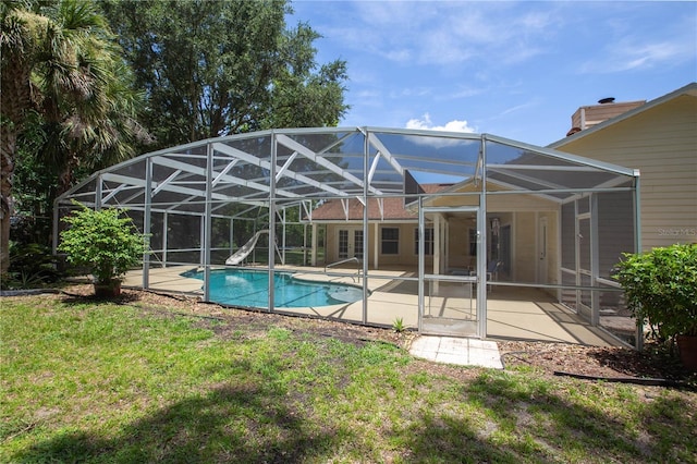 14933 Thoroughbred Ln, Montverde, FL 34756 - rear view of house featuring a patio area, an outdoor pool, a yard, and glass enclosure
