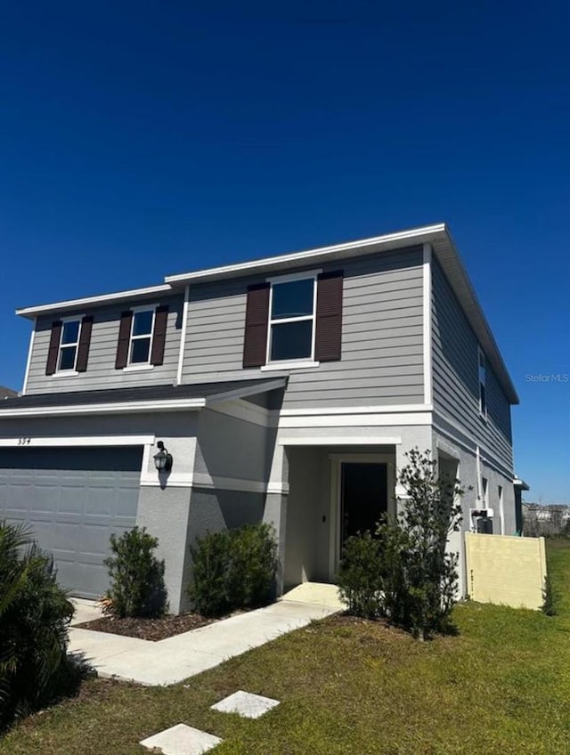 594 Preserve Pt, Davenport, FL 33837 - traditional-style home featuring an attached garage, a front yard, and stucco siding