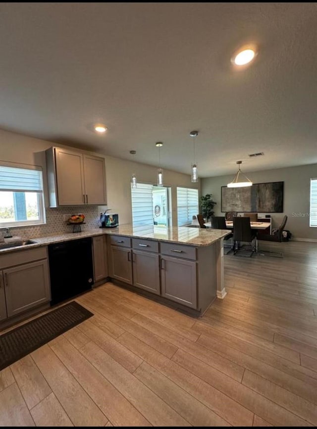 594 Preserve Pt, Davenport, FL 33837 - kitchen featuring dishwasher, gray cabinetry, plenty of natural light, light wood-style floors, and recessed lighting