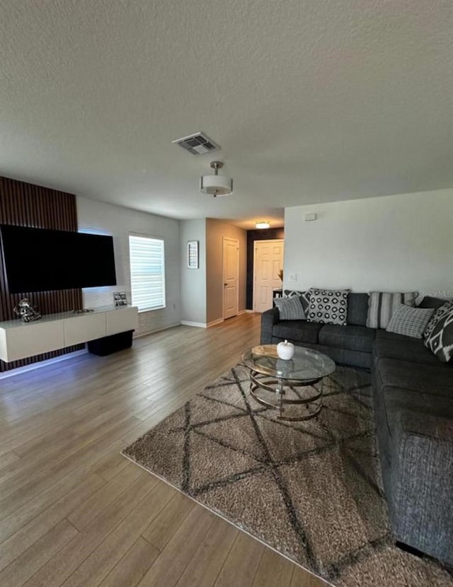 594 Preserve Pt, Davenport, FL 33837 - living area featuring wood finished floors and a textured ceiling