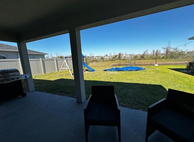 594 Preserve Pt, Davenport, FL 33837 - fenced backyard featuring a patio, grilling area, and a playground