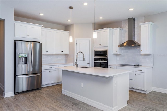 111 Bottle Brush Dr, Haines City, FL 33844 - kitchen featuring stainless steel appliances, wall chimney range hood, backsplash, wood finished floors, and recessed lighting