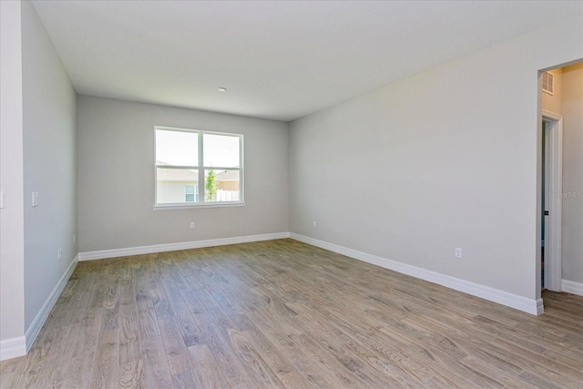 111 Bottle Brush Dr, Haines City, FL 33844 - empty room with light wood-style flooring and baseboards
