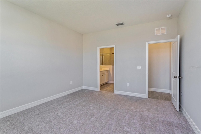 111 Bottle Brush Dr, Haines City, FL 33844 - unfurnished bedroom featuring carpet and ensuite bathroom