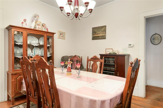 709 Daphne Ave, Umatilla, FL 32784 - dining area with a chandelier, ornamental molding, and wood finished floors