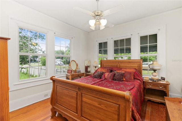 709 Daphne Ave, Umatilla, FL 32784 - bedroom with light wood-style flooring, ornamental molding, and a ceiling fan