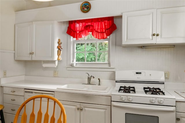 709 Daphne Ave, Umatilla, FL 32784 - kitchen with white range with gas cooktop, dishwashing machine, light countertops, and white cabinets