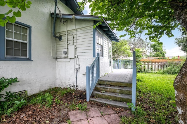 709 Daphne Ave, Umatilla, FL 32784 - view of side of home with stucco siding and a deck