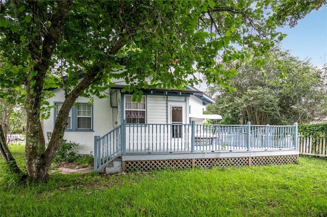 709 Daphne Ave, Umatilla, FL 32784 - rear view of house featuring a wooden deck and stucco siding