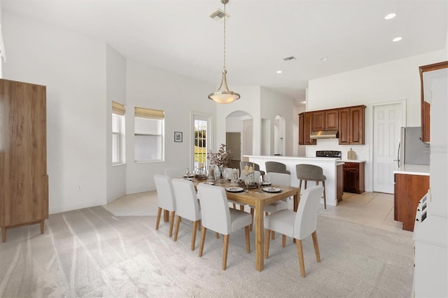 6109 Spinnaker Loop, Lady Lake, FL 32159 - dining space with arched walkways, light colored carpet, and recessed lighting