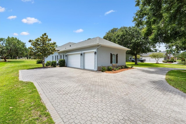 6109 Spinnaker Loop, Lady Lake, FL 32159 - view of home's exterior featuring a garage, stucco siding, a lawn, decorative driveway, and stone siding