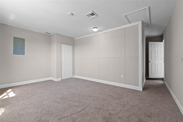 4751 Deer Run Rd, Saint Cloud, FL 34772 - carpeted spare room with electric panel, a textured ceiling, and attic access