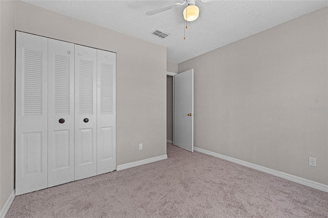 4751 Deer Run Rd, Saint Cloud, FL 34772 - unfurnished bedroom featuring carpet floors, a closet, a textured ceiling, and ceiling fan
