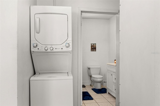 750 N Kentucky Ave, Umatilla, FL 32784 - bathroom featuring stacked washing machine and dryer, tile patterned floors, and vanity