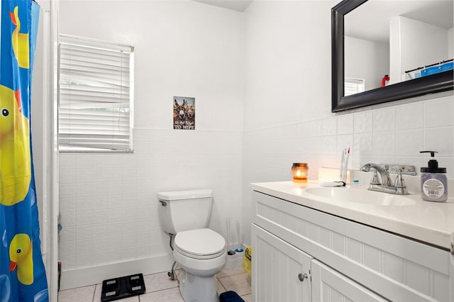 750 N Kentucky Ave, Umatilla, FL 32784 - bathroom featuring vanity, tile patterned flooring, tile walls, a shower with shower curtain, and wainscoting
