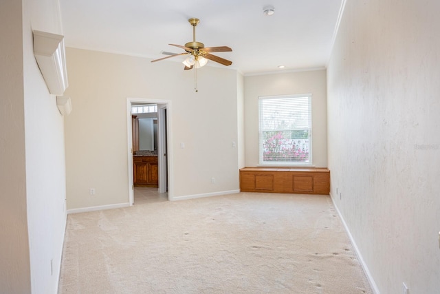 unfurnished room with light colored carpet and ceiling fan