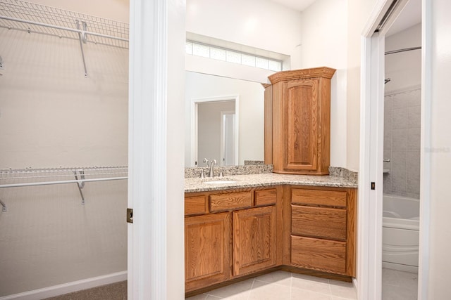 full bathroom with tiled shower / bath, vanity, toilet, and tile floors