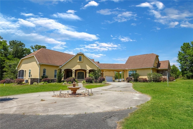 view of front of home with a garage and a front lawn