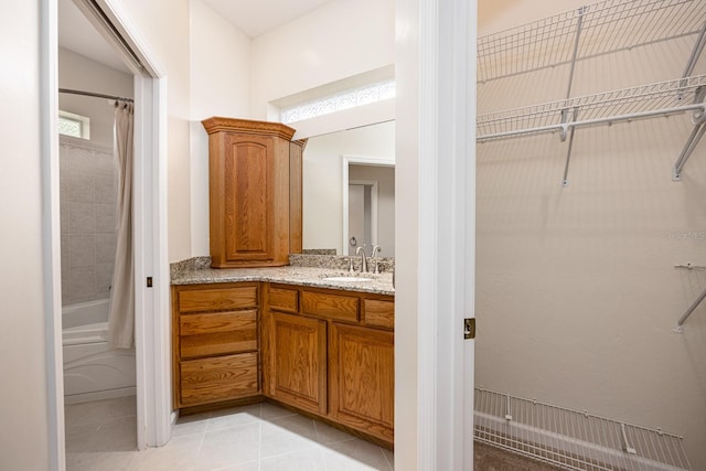 bathroom featuring shower / bath combination with curtain, tile floors, and vanity with extensive cabinet space