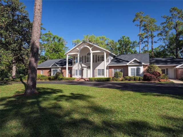 greek revival inspired property with a front lawn