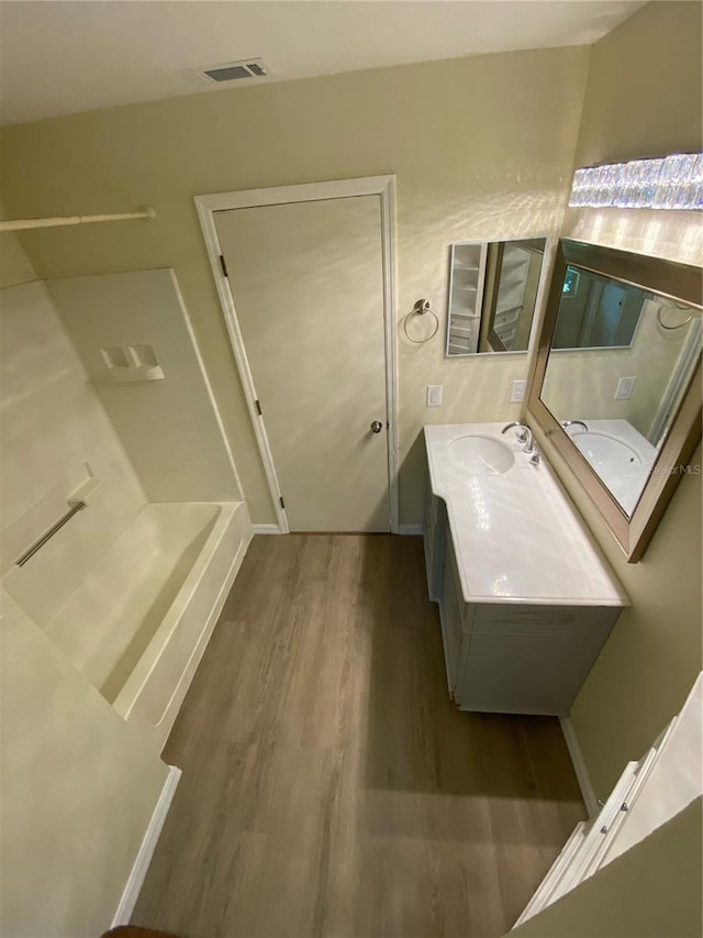 bathroom with vanity and hardwood / wood-style flooring