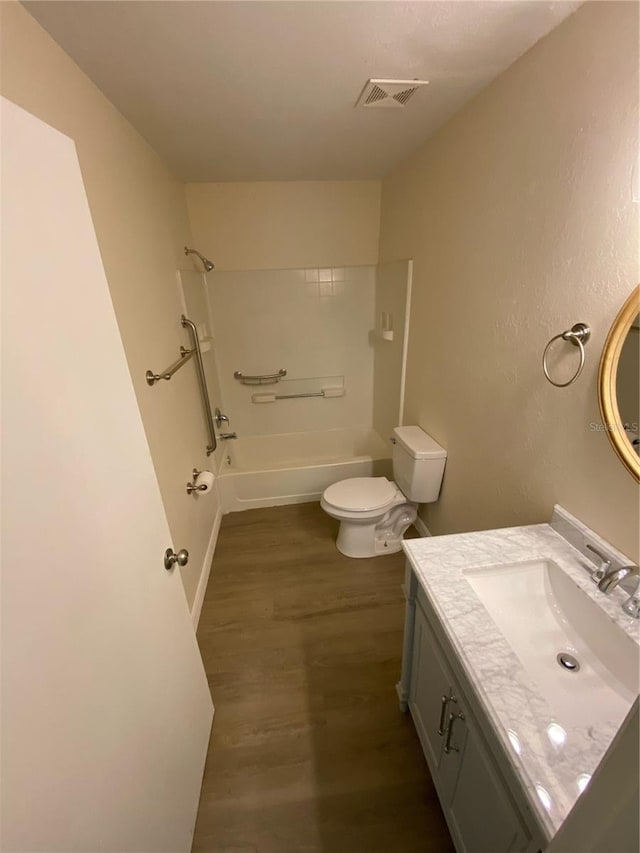 full bathroom featuring vanity, tub / shower combination, wood-type flooring, and toilet