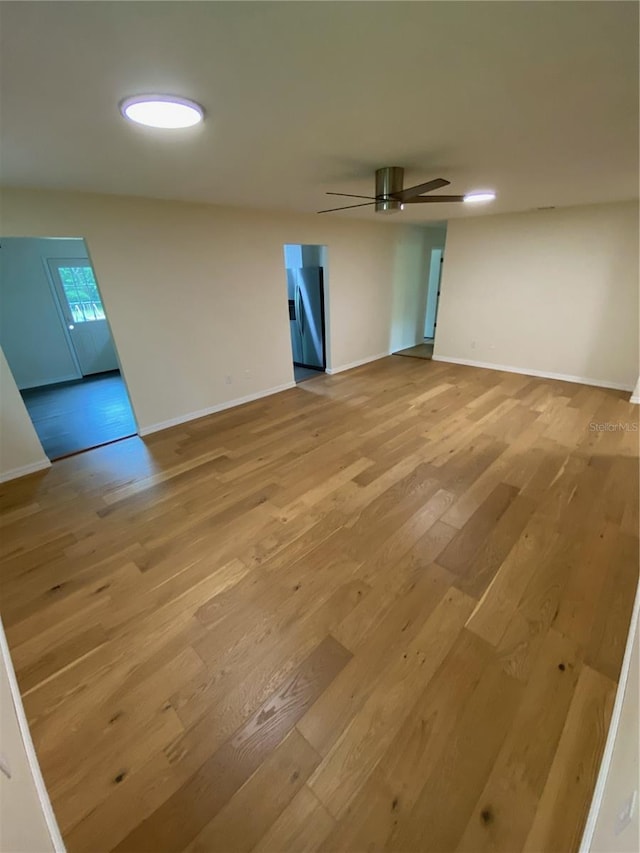 unfurnished room featuring ceiling fan and light hardwood / wood-style floors