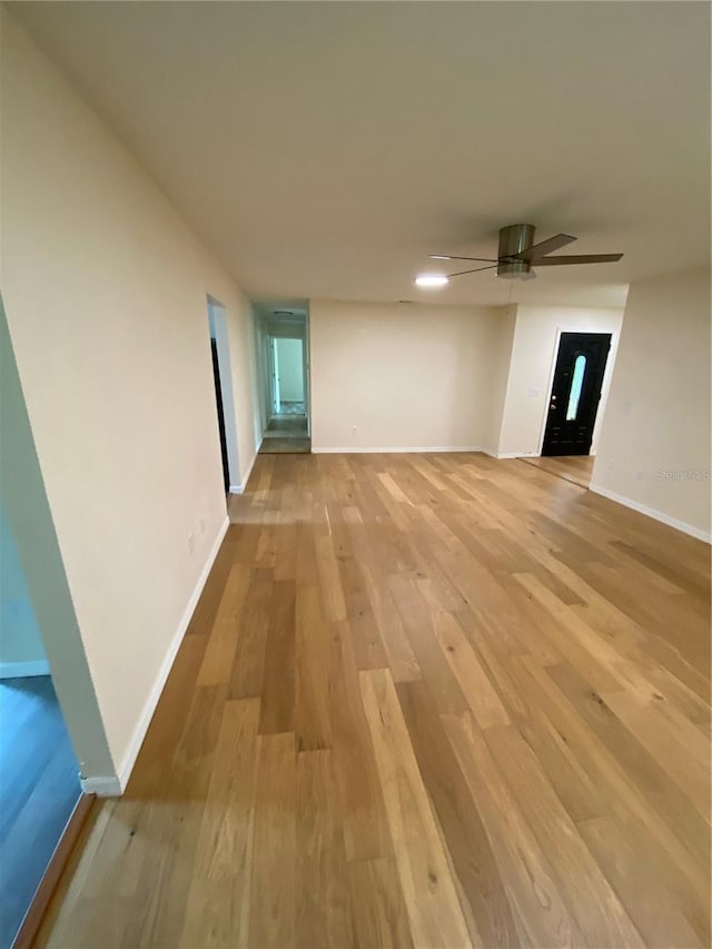 unfurnished room featuring light hardwood / wood-style floors and ceiling fan