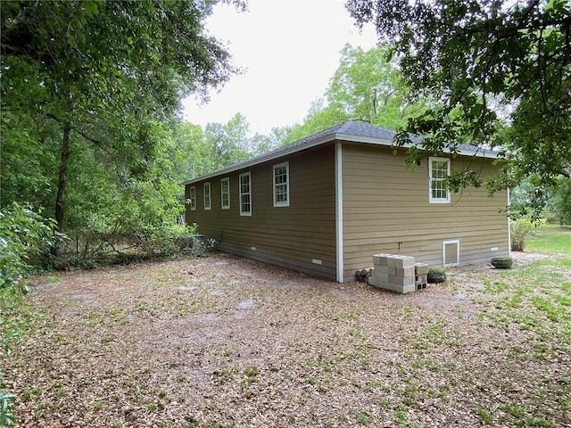 view of side of property with central air condition unit