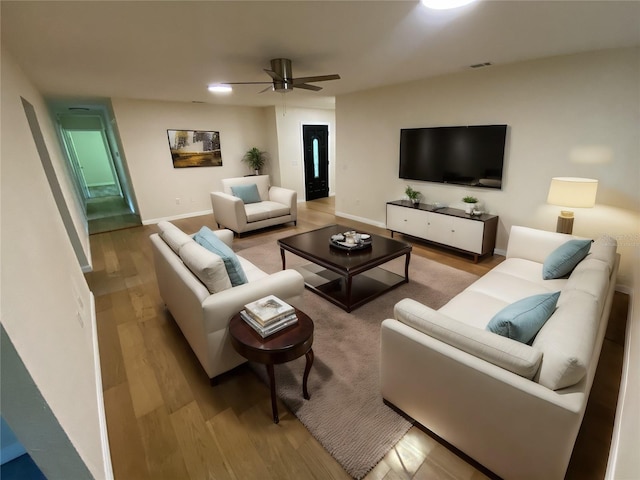 living room featuring ceiling fan and light hardwood / wood-style flooring