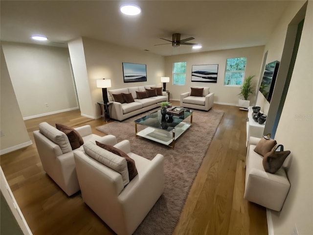 living room with ceiling fan and light wood-type flooring