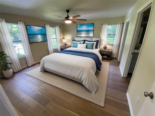 bedroom featuring multiple windows, ceiling fan, and hardwood / wood-style floors