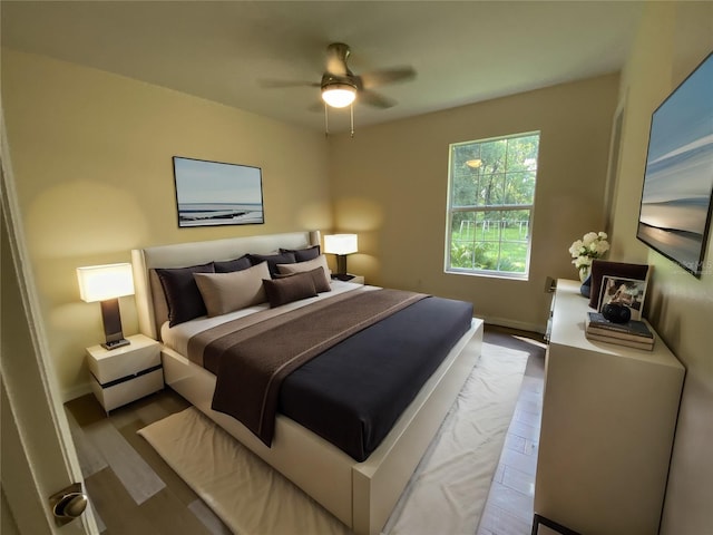 bedroom featuring light hardwood / wood-style flooring and ceiling fan